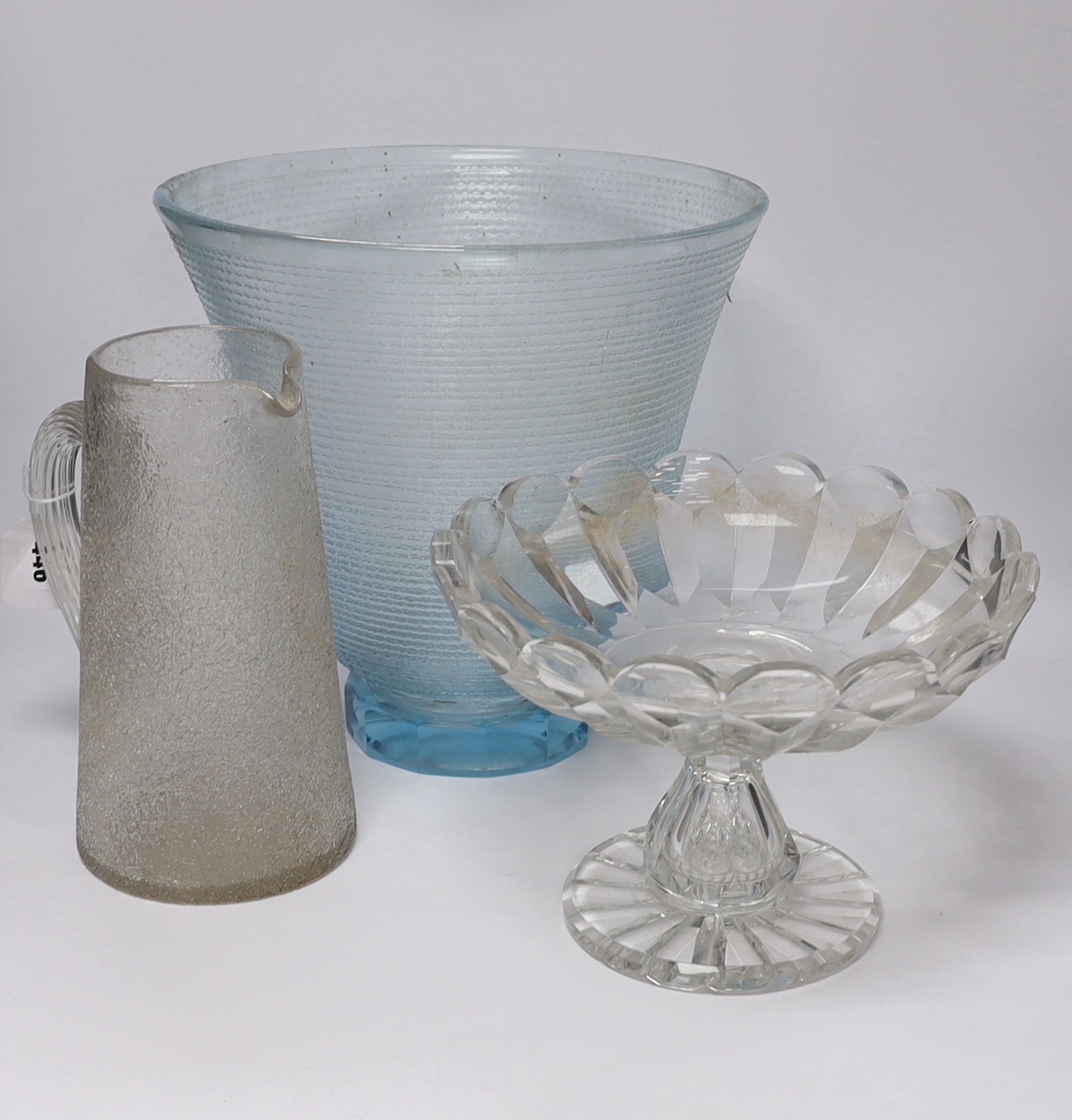 A large heavy cut glass tazza with shaped rim, a tall blue tinted textured vase, height 31.5cm and a crackle finish water jug (3)